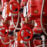 Red steam valves and other preasure equipment in industrial facility